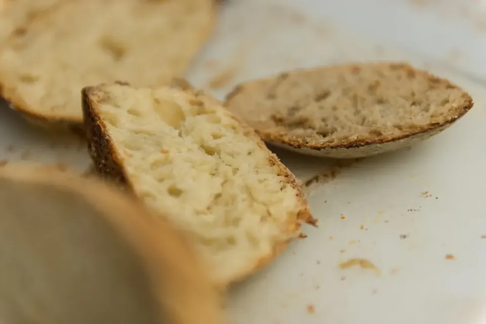 Close-up of slices of sourdough bread showing an open, airy crumb