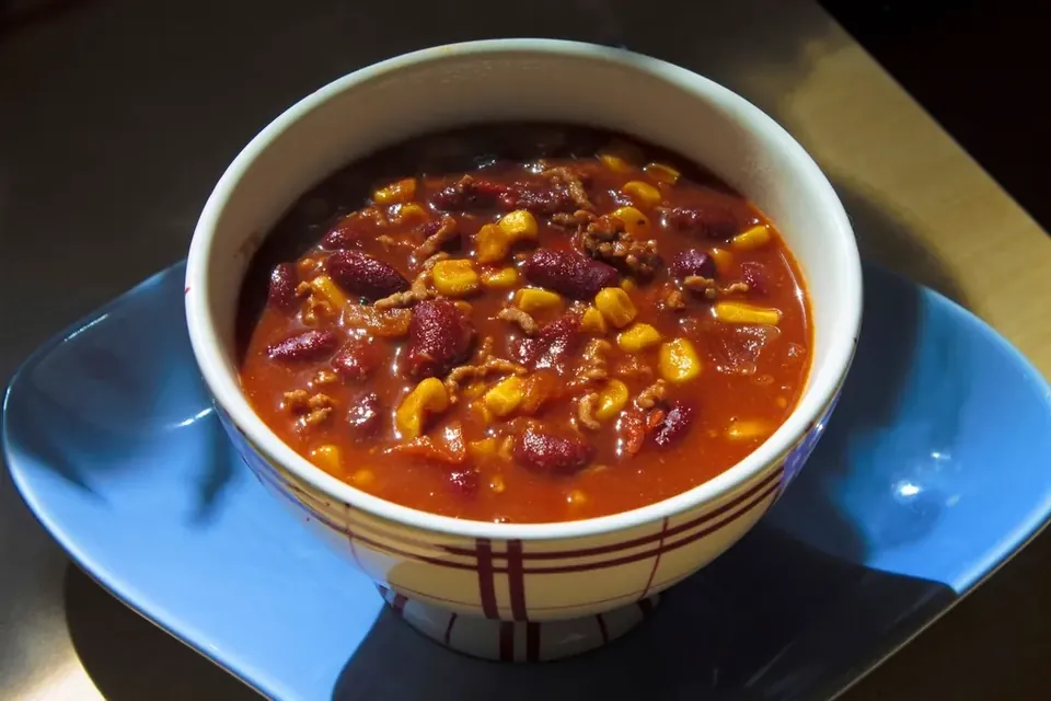 A white bowl of creamy grain and vegetable soup